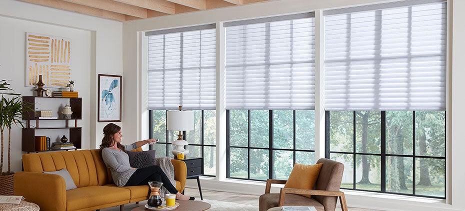 Woman on Couch Operating Motorized Shades