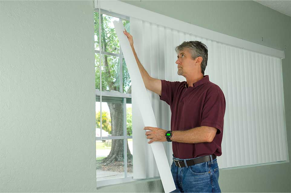 Man Hanging new Slat for Vertical Blinds