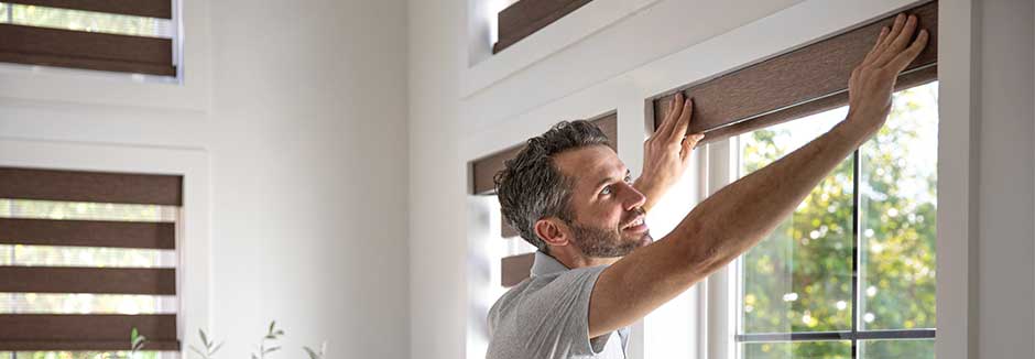 Professional Installer installing new window treatments