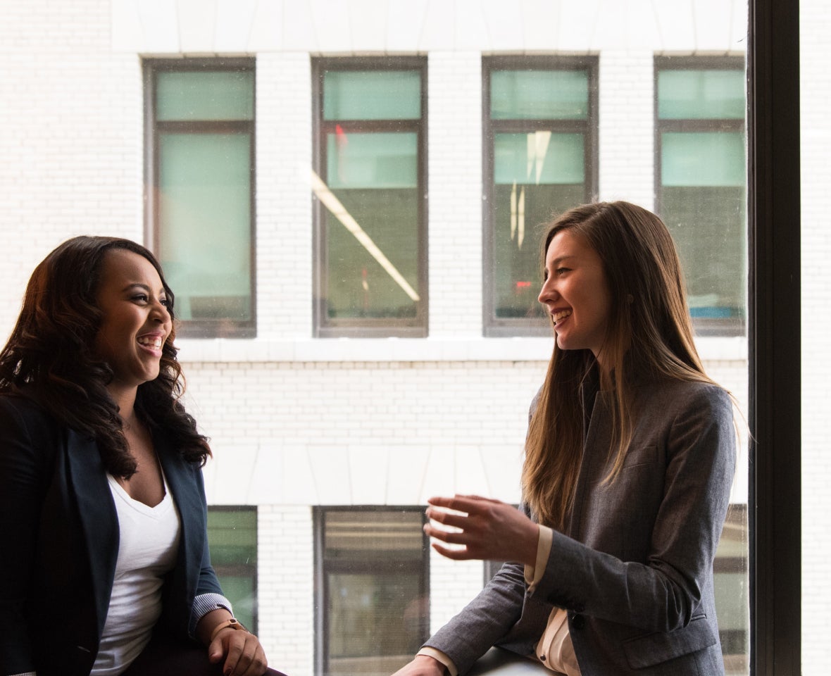 Two team members share a moment of levity at one of our offices.